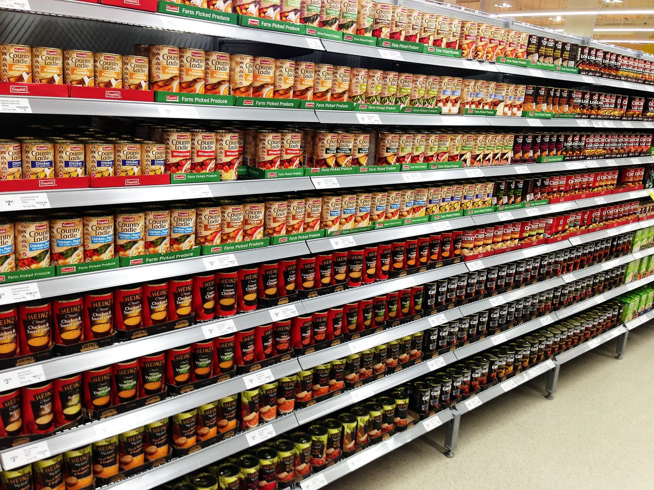 Supermarket shelves display soups and other packaged food.