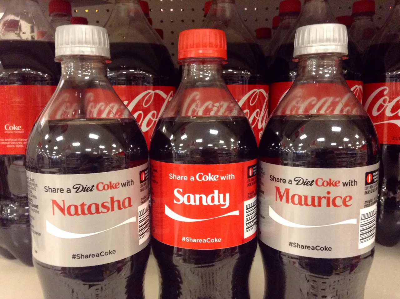 Coca-Cola bottles with personalized names on their labels.