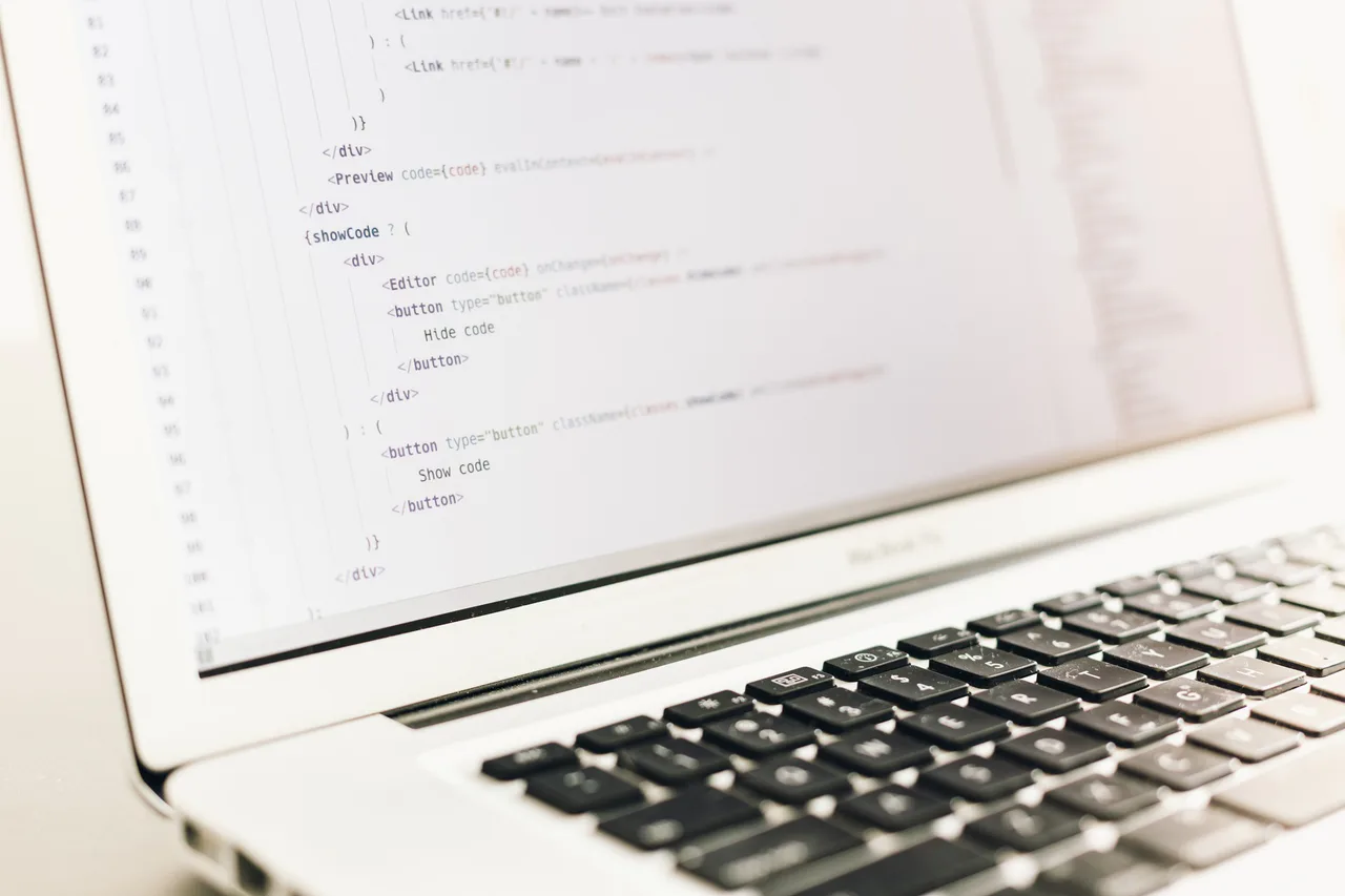 Code displayed on a laptop screen above its keyboard