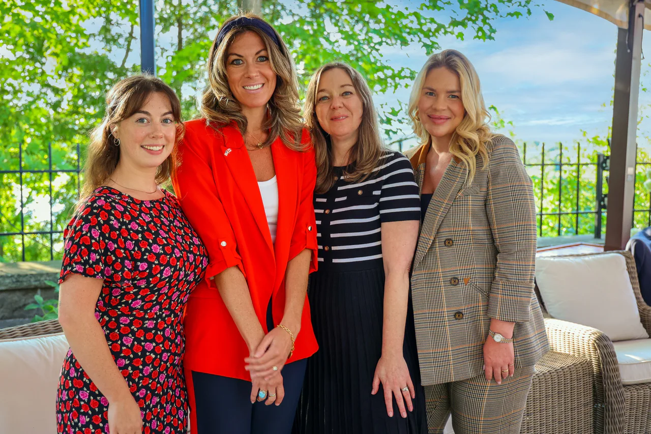 Four people pose together at an entrepreneurship event.