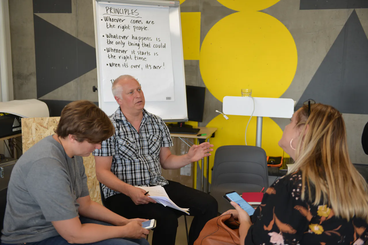 Three participants discussing data management at a workshop