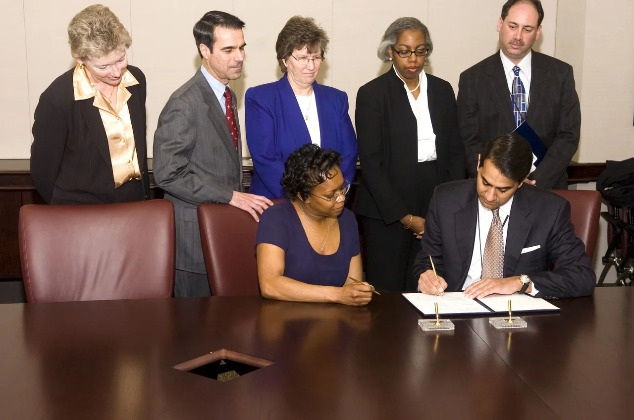 People gathered for the signing of a document.