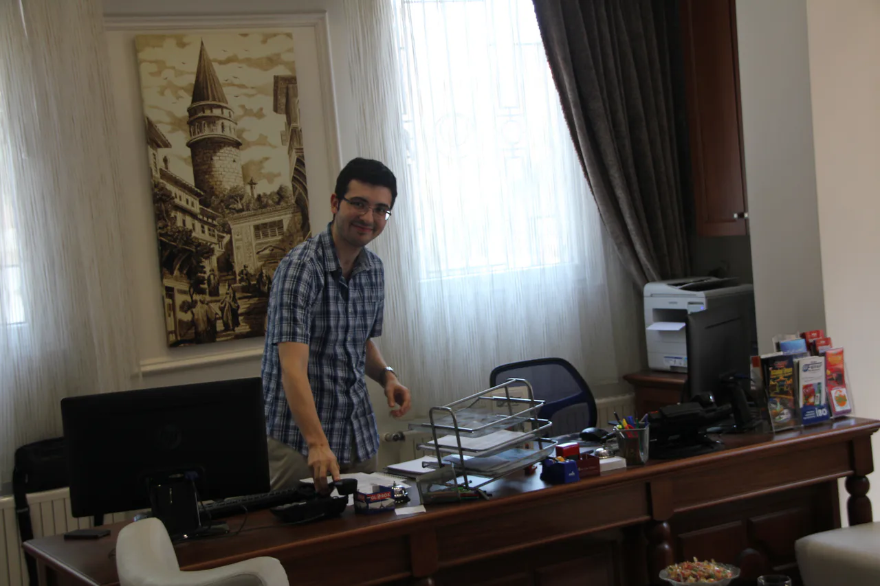 A receptionist behind the counter at the Aren Suites Hotel in Istanbul
