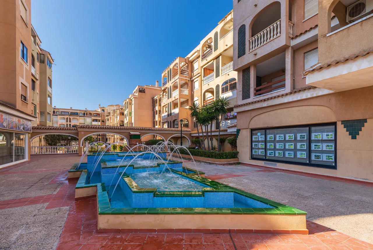 Residential buildings and commercial premises around a fountain in Torrevieja.