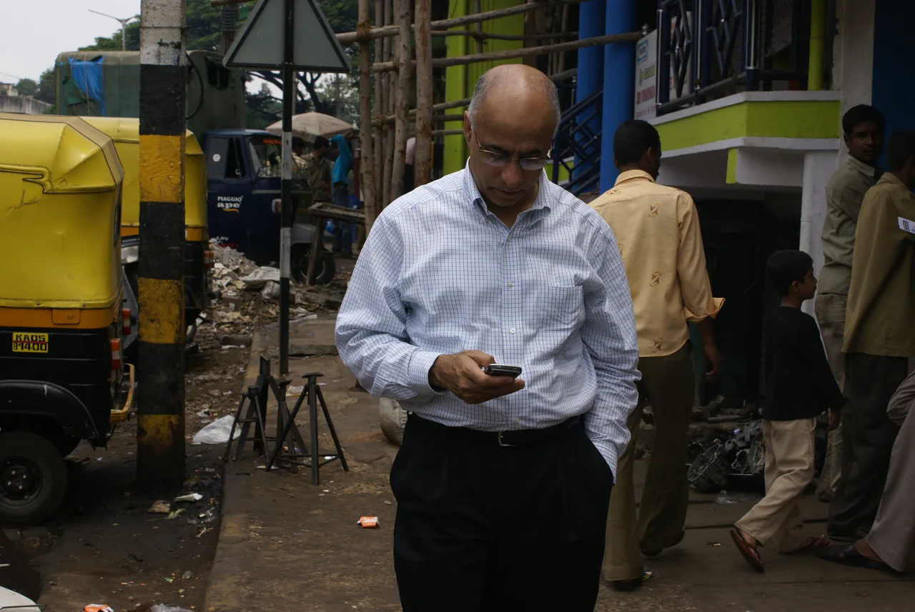 Person checking email on a phone in a street
