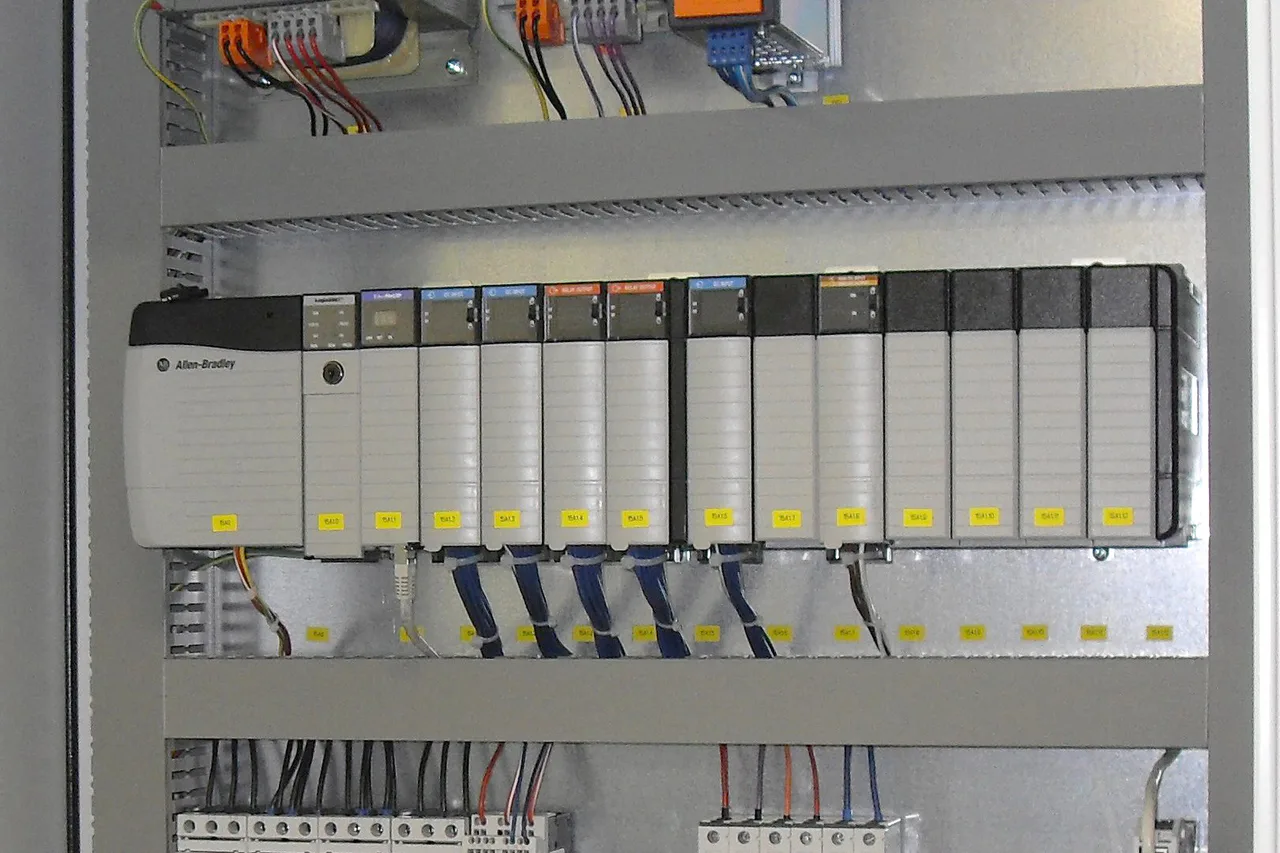 An Allen-Bradley PLC and wired modules inside an industrial control cabinet